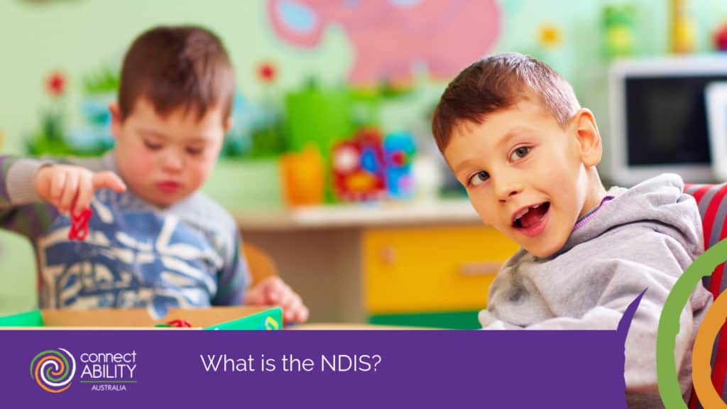 two young boys playing with toys in a colourful classroom setting