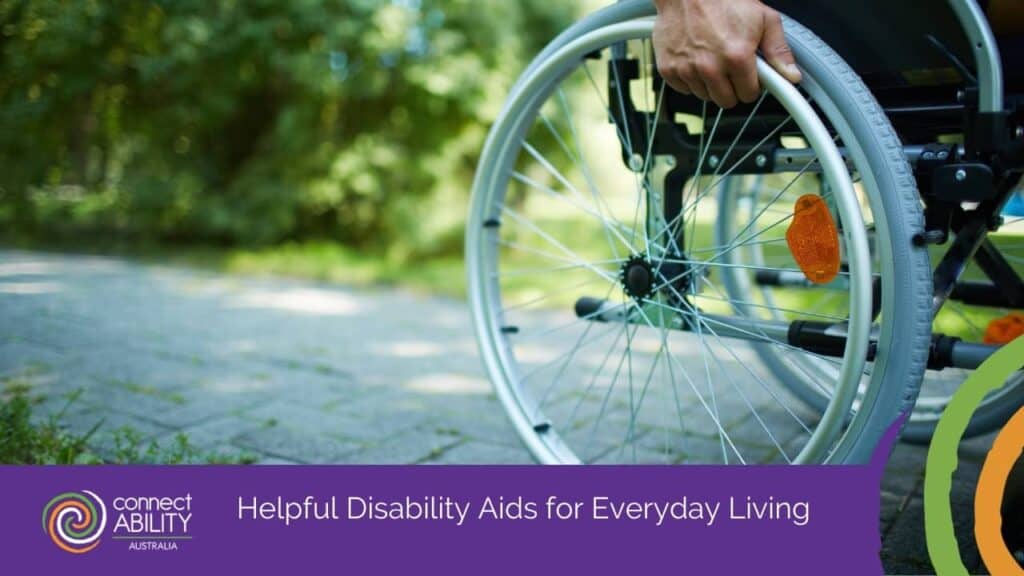 Close-up of a person's hand on a wheelchair wheel outdoors