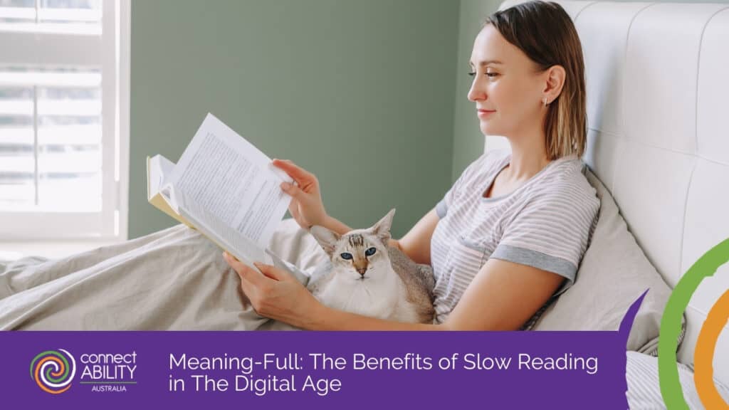 A woman reads a book in bed with a cat resting on her lap