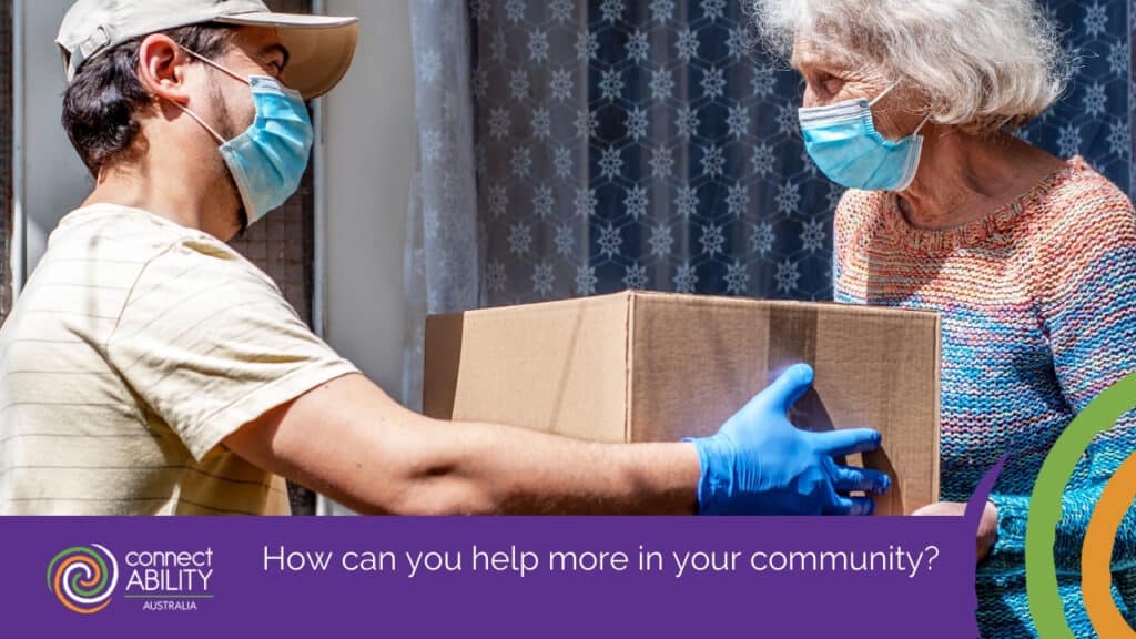 A delivery person wearing a face mask and gloves handing a cardboard box to an elderly woman who is also wearing a face mask
