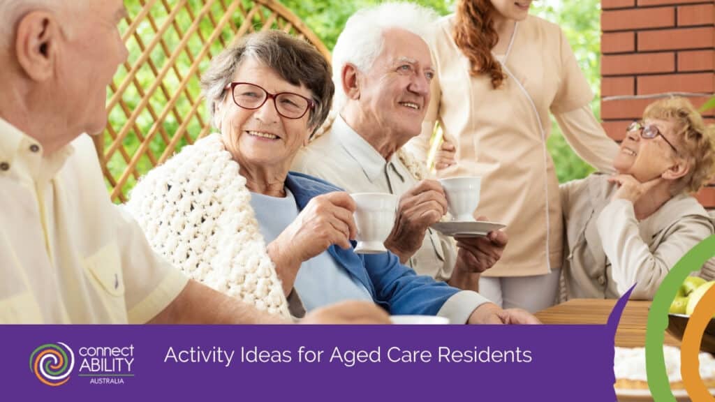 A group of seniors smiling and enjoying tea outdoors with a caregiver