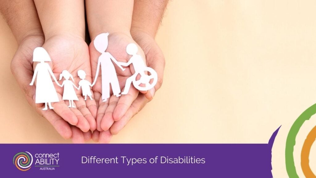 Two hands cupped together holding white paper cutouts of a family, including a person in a wheelchair