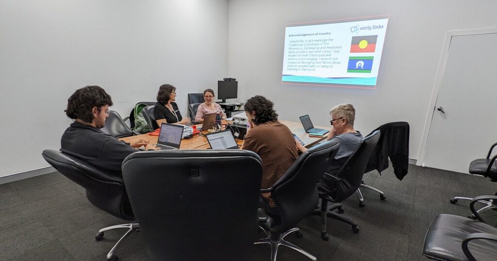 A group of people sitting around a conference table in an office setting
