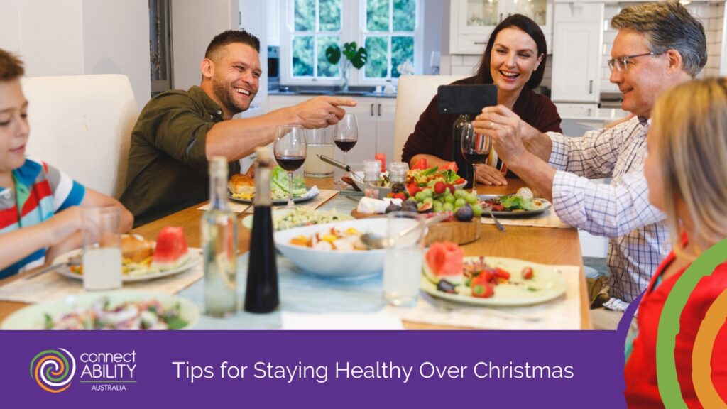 A group of adults and children laughing and taking a photo with a smartphone while enjoying a healthy meal together