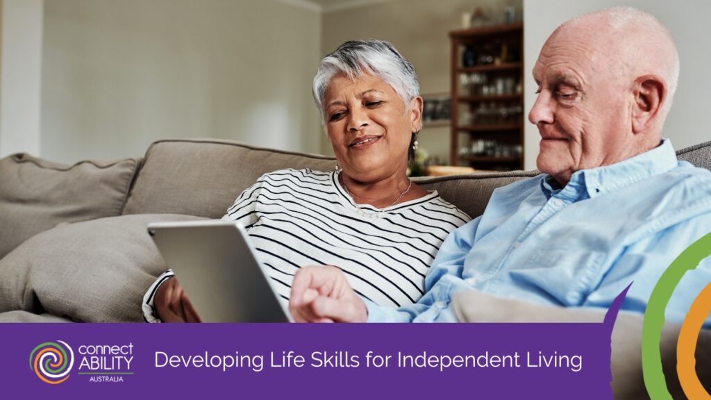An older couple sits comfortably on a couch while looking at a tablet together