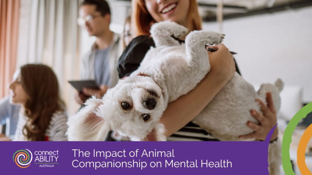 A woman smiles while holding a small, white fluffy dog in her arms in an office setting.