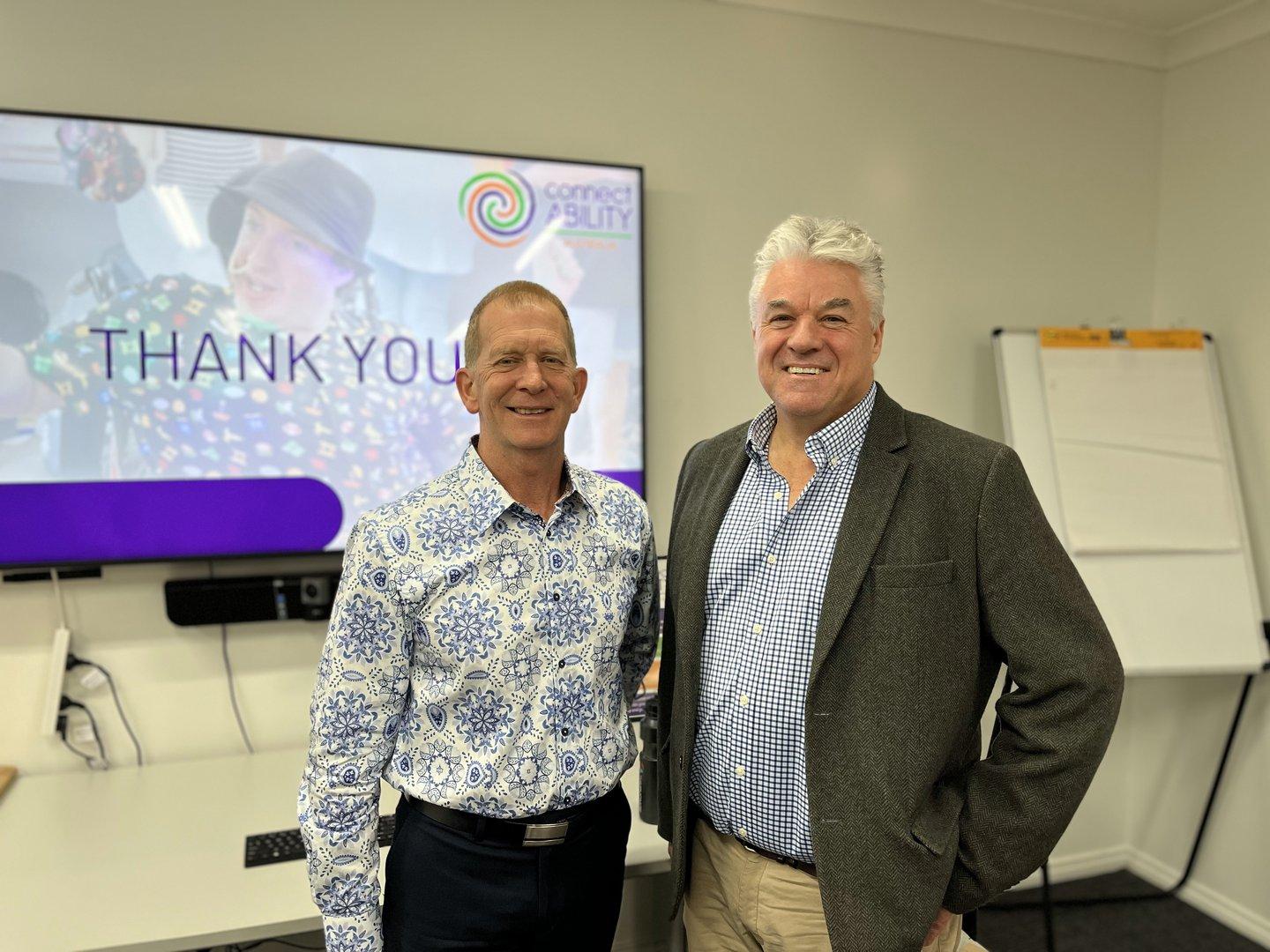David and Jim, representatives from ConnectAbility, standing together during a community event.
